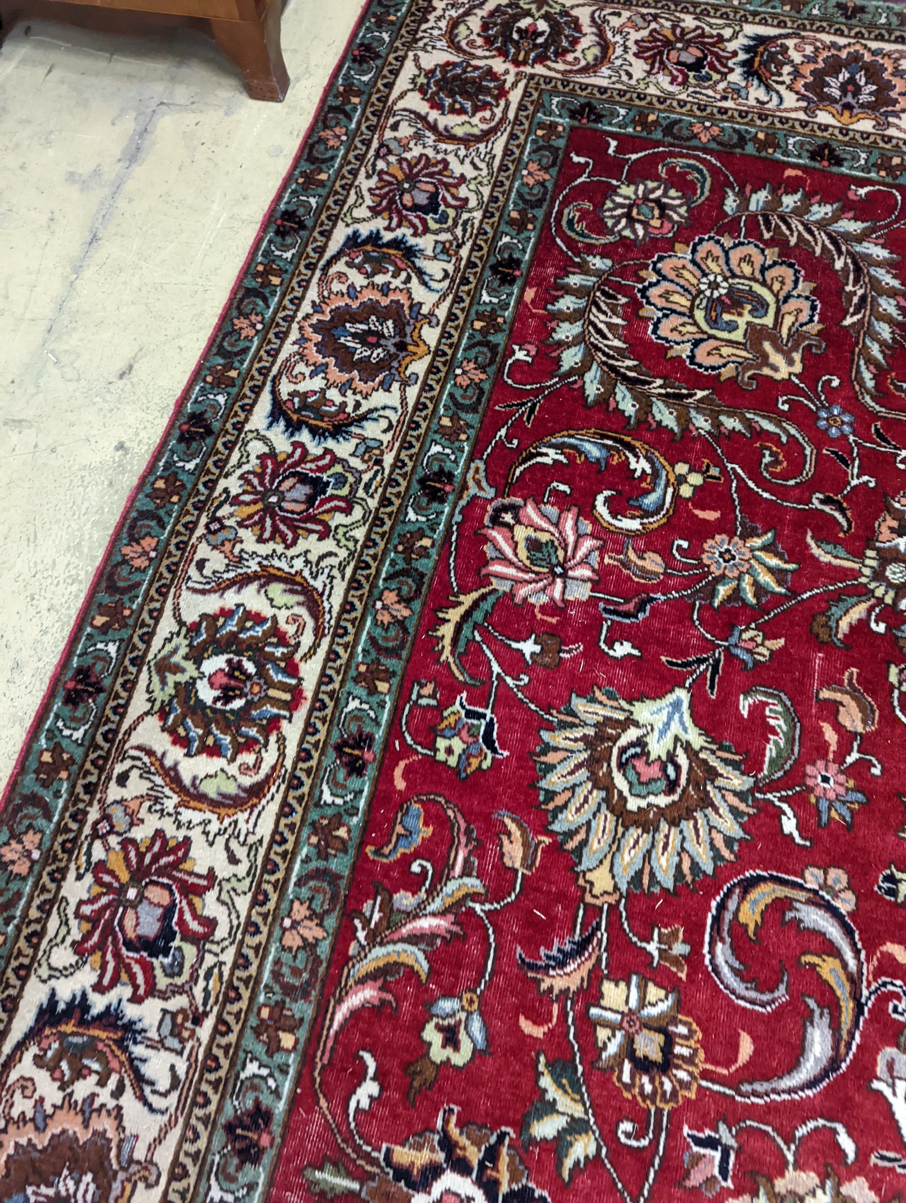 A Tabriz red ground carpet, 400 x 290cm